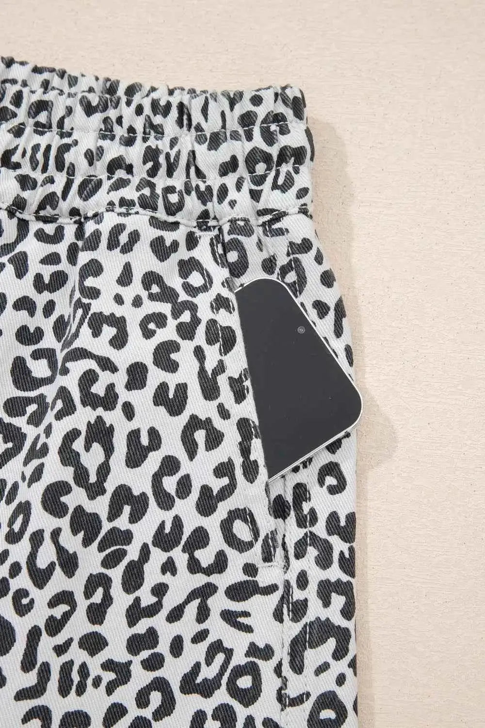 Leopard Print Tassel casual denim skort with black and white leopard pattern and side pocket holding a phone