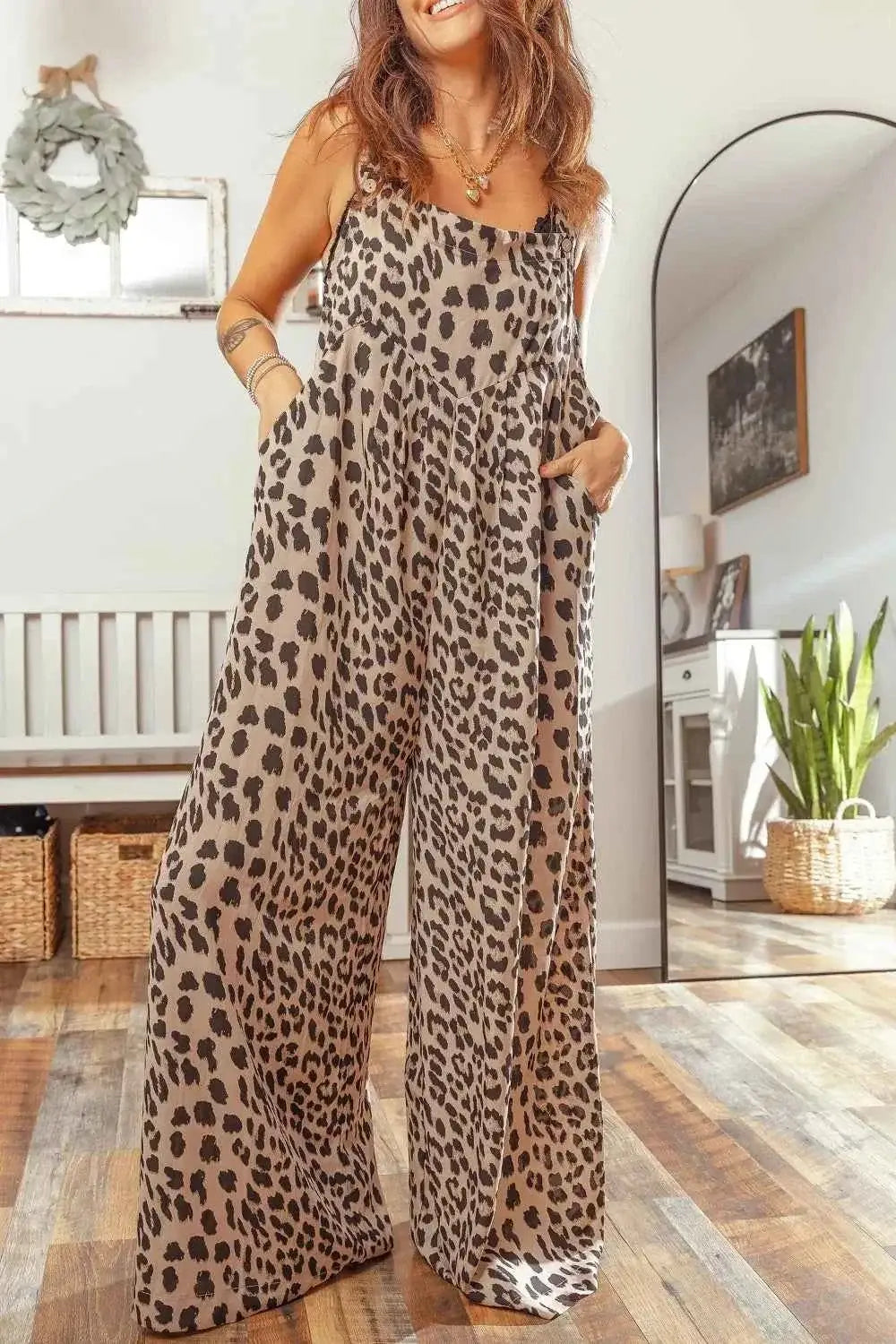 Leopard Print sleeveless wide leg jumpsuit with square neckline, pleated fabric, and side pockets in beige and black pattern