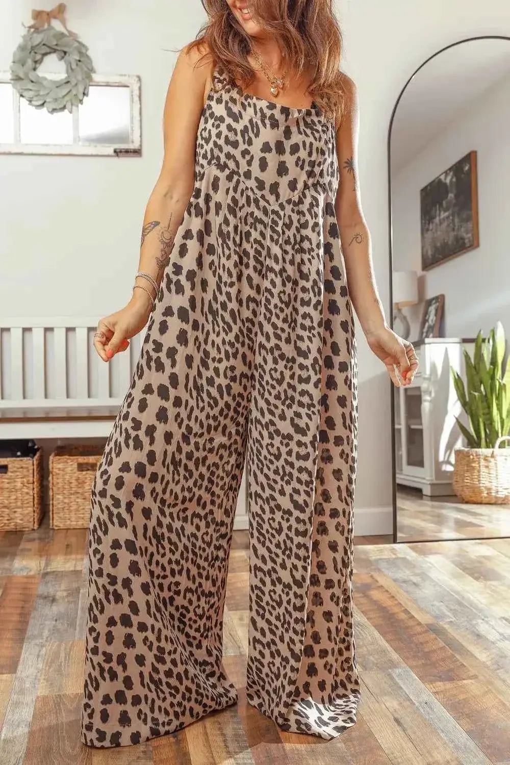 Leopard Print sleeveless wide leg jumpsuit with pleated square neck and loose fit in beige and black spotted pattern