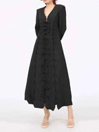 Long Sleeve Bow Front black midi dress in polyester featuring long sleeves, scalloped edges, and a vertical row of bow details