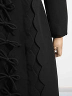 Long Sleeve Bow Front black polyester midi dress with multiple bows and scalloped edge detail on side