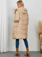 Long Sleeve Longline Hooded Winter Coat in beige polyester with quilted pattern and side pockets shown from back