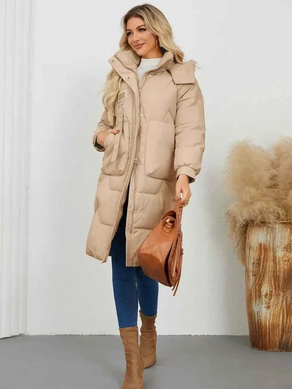 Long Sleeve Longline Hooded Winter Coat in beige polyester with front pockets and quilted pattern on a woman