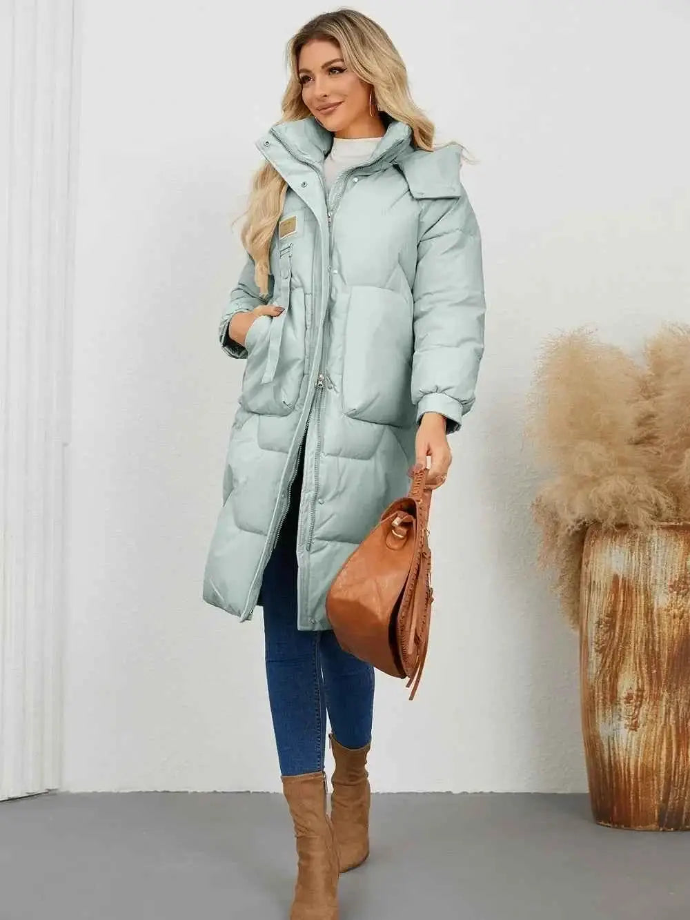 Long Sleeve Longline Hooded Winter Coat in light blue polyester with pockets and normal thickness worn with jeans and beige boots