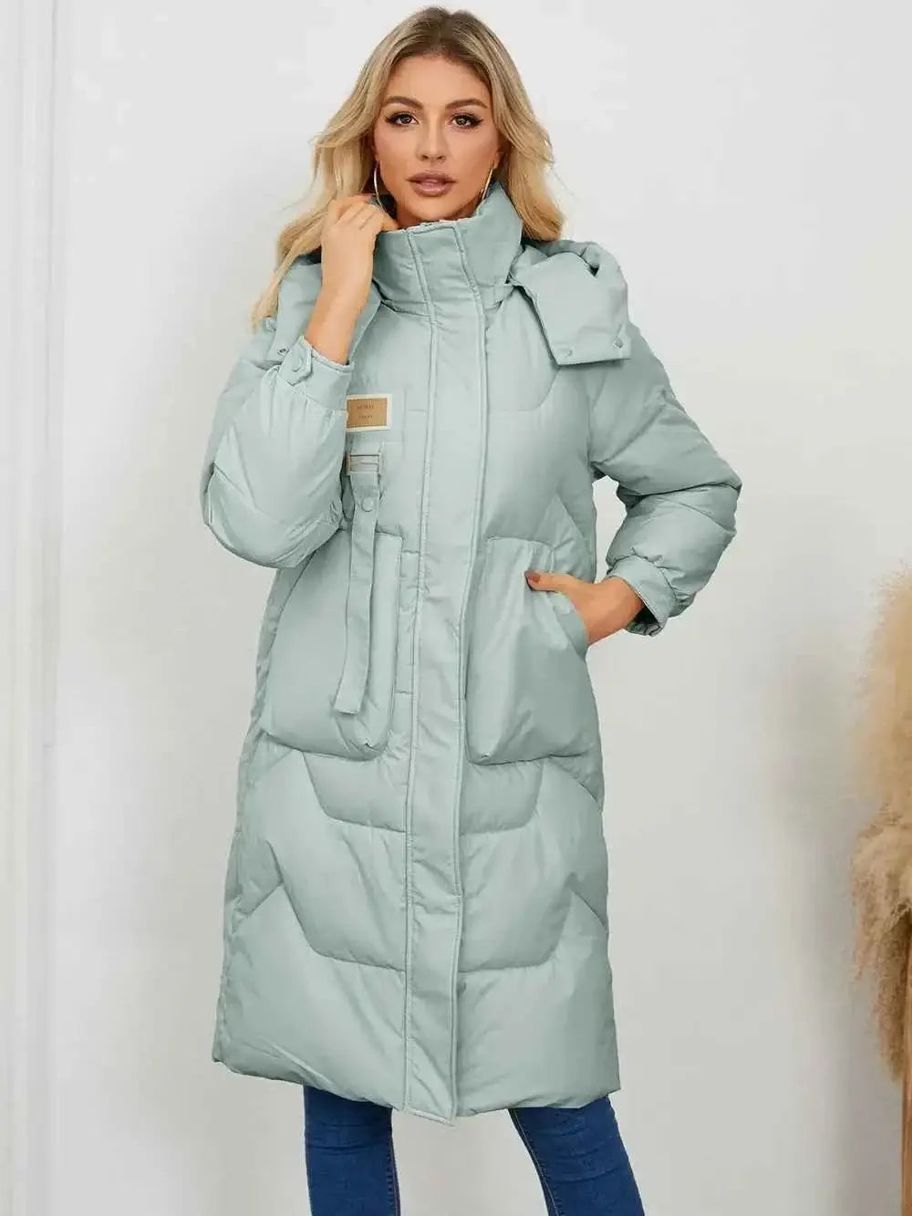 Long Sleeve Longline Hooded Winter Coat in light blue polyester with pockets and quilted pattern, worn by a model