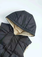 Longline Padded Hooded Vest in black polyester with beige lining, zipper front, and padded quilted design