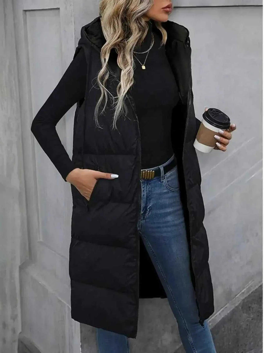 Longline Padded Hooded Vest in black polyester with front zipper, side pockets, and quilted pattern
