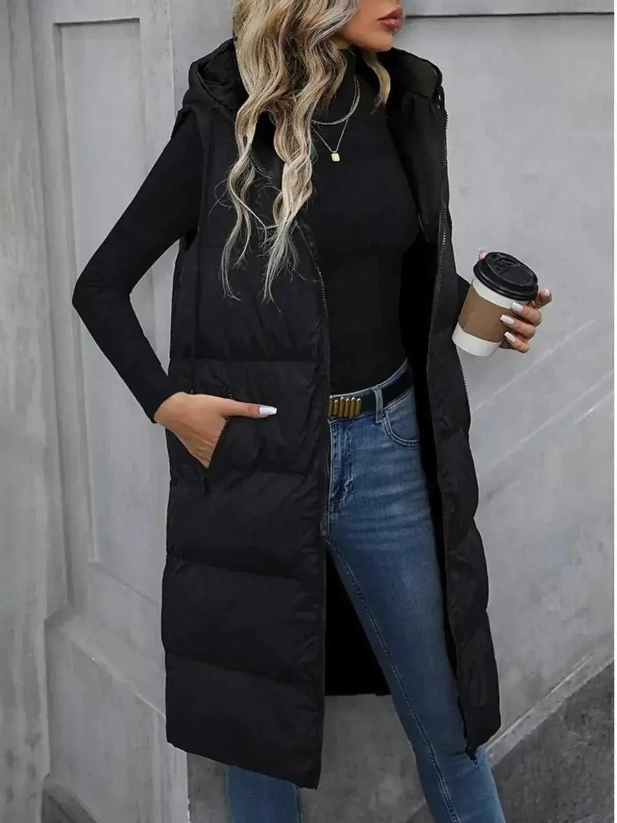 Longline Padded Hooded Vest in black polyester with front zipper, side pockets, and quilted pattern