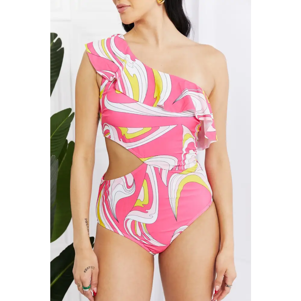 Elevate poolside style with the retro-inspired cutout swimsuit $37.99 bold and printed with a vibrant retro design,