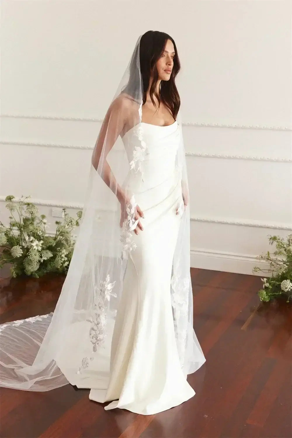 Maternity Mermaid Wedding Dress in white silk satin with strapless neckline, empire waist, sleeveless mermaid silhouette and delicate appliques