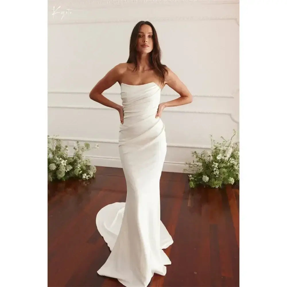 Maternity Mermaid Wedding Dress in white silk satin with strapless neckline and fitted mermaid silhouette on model