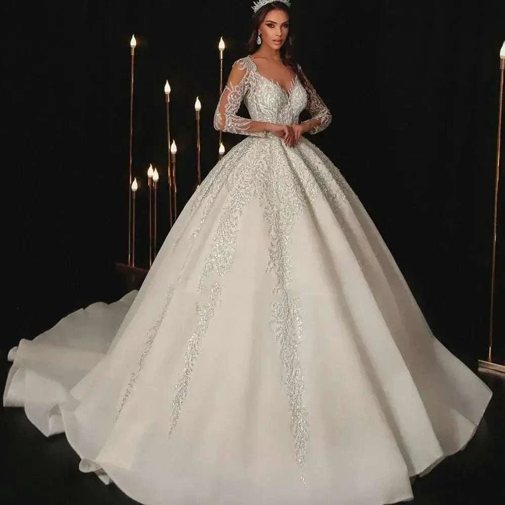Modern Wedding Dresses white A-line bridal gown with lace appliques, full sheer sleeves, V-neckline, and floor-length sweep train