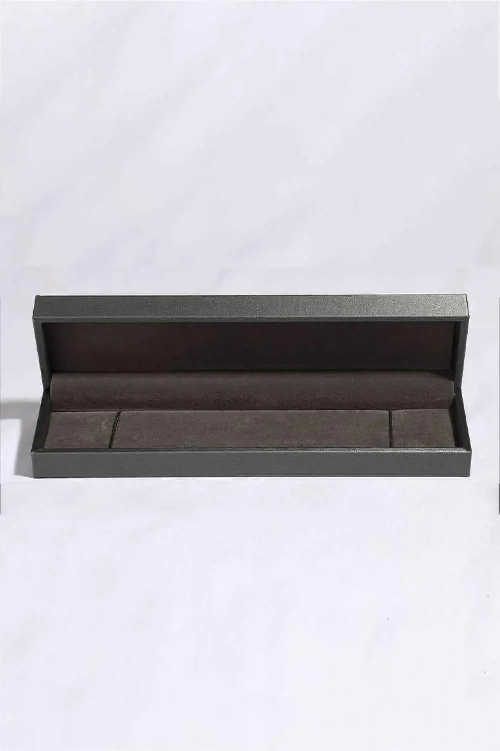 Empty rectangular jewelry box with dark exterior and soft brown velvet interior suitable for a Moissanite Bracelet