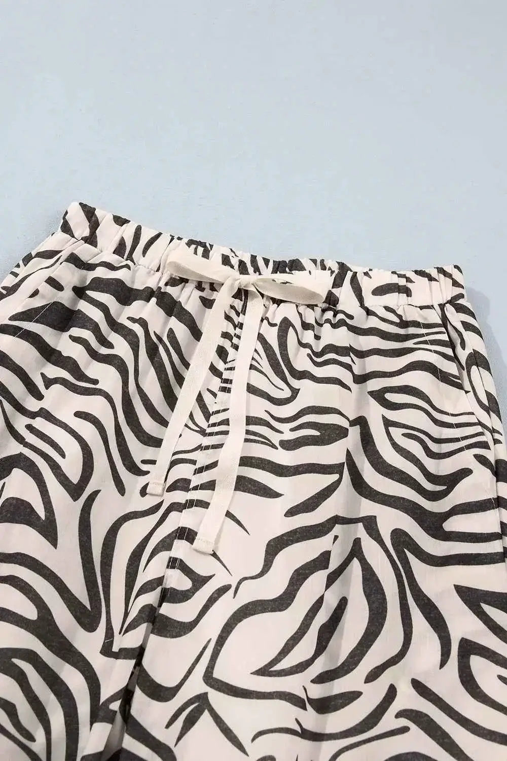 Multicolour Western Print elastic waist pants with black and white zebra pattern, drawstring, and side pockets