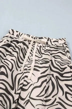Multicolour Western Print elastic waist pants with black and white zebra pattern, drawstring, and side pockets