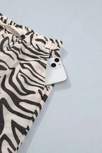 Multicolour Western Print zebra pattern elastic waist pocket pants with black and white stripes and a phone in the pocket