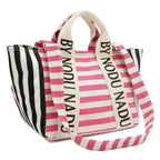 Nicole Lee USA striped tote bag with pink and white stripes on front, black and white stripes on sides, and logo-printed beige shoulder straps