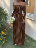 Off-the-Shoulder Maxi Dress in brown fabric with white polka dots, featuring long sleeves and a fitted, floor-length silhouette.