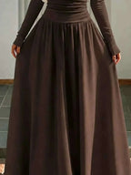 Off-the-Shoulder Maxi Dress in dark brown lightweight fabric with a full-length, flowing skirt and fitted waist.