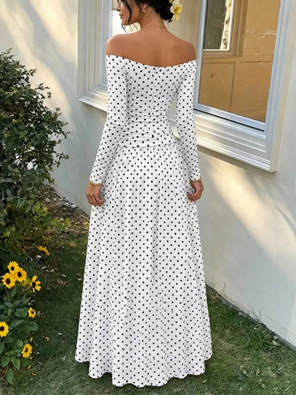 Off-the-Shoulder Maxi Dress in white with black polka dots, long sleeves, fitted bodice, and flowing full-length skirt