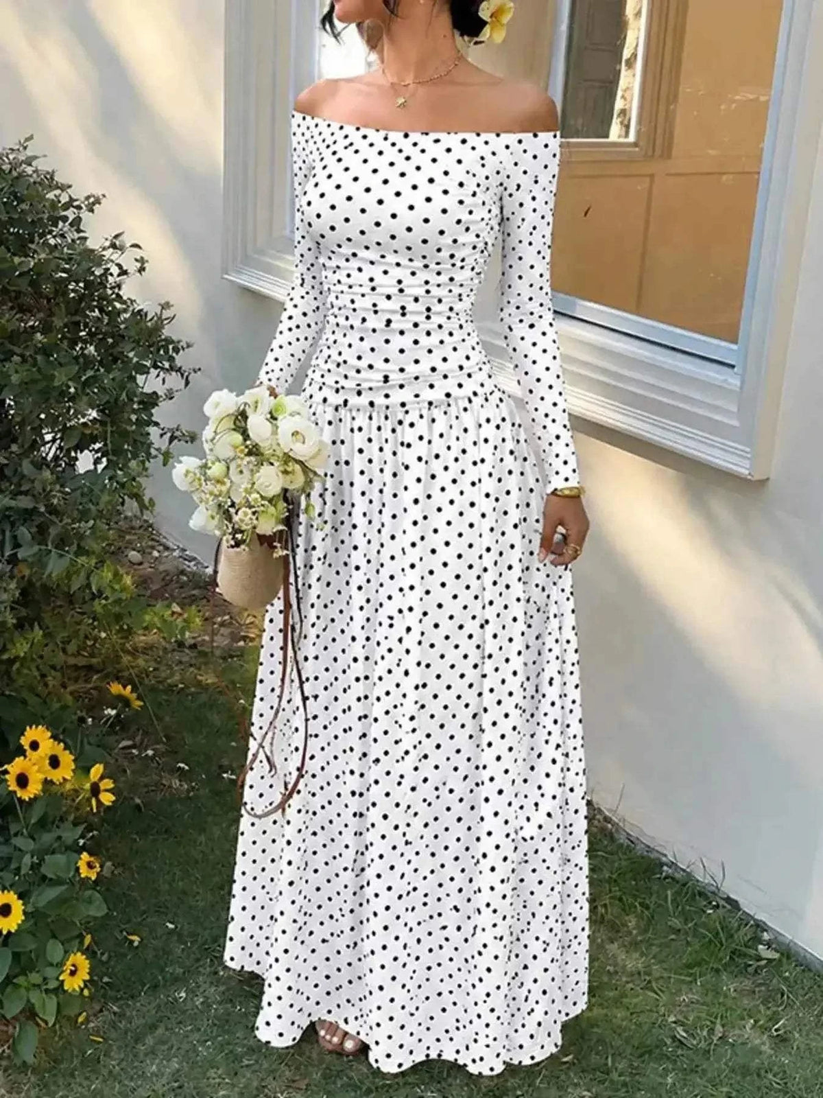 Off-the-Shoulder Maxi Dress in white with black polka dots, lightweight fabric, long sleeves, and a flowing full-length skirt.