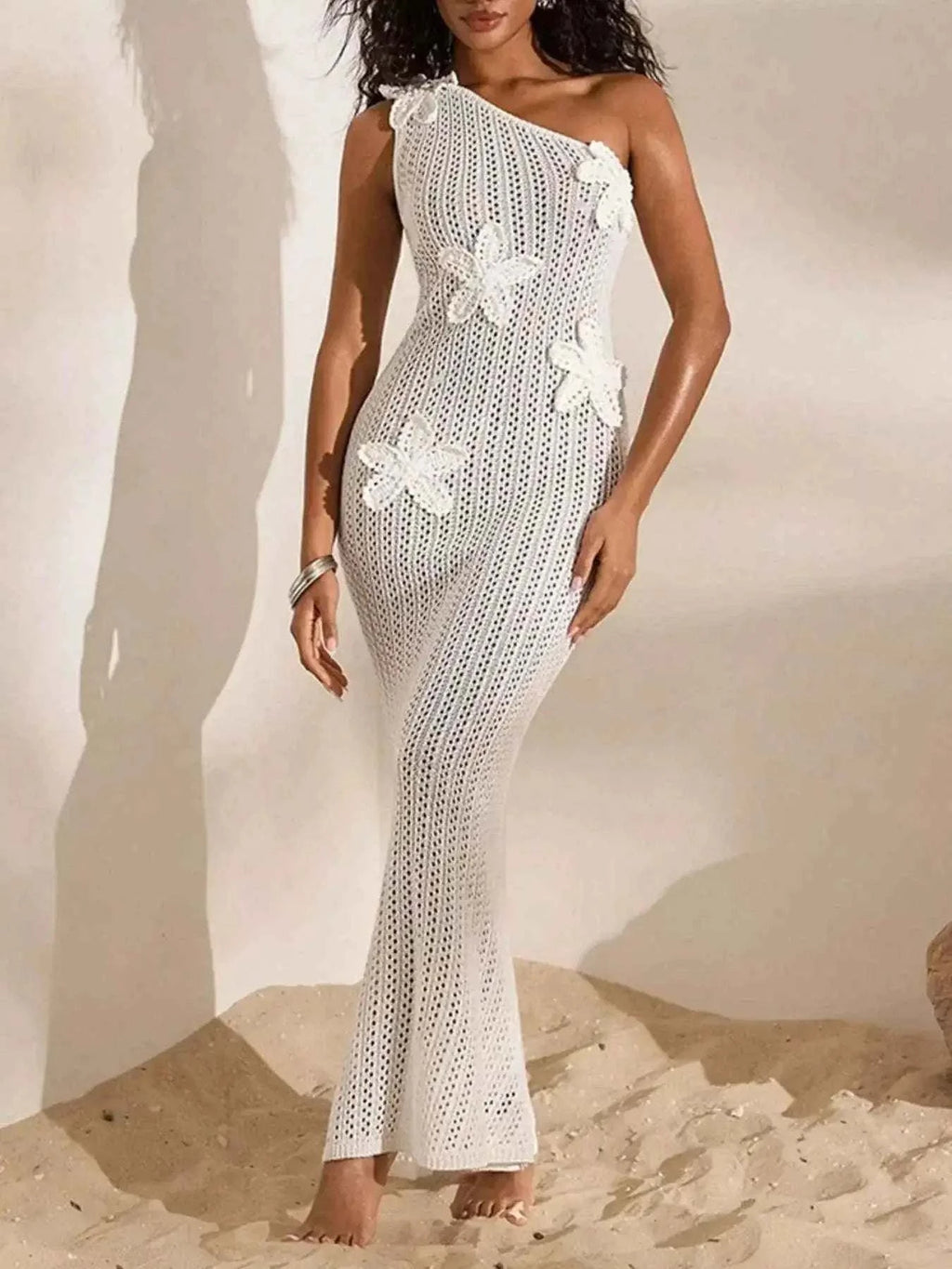 White one-shoulder crochet maxi dress with openwork pattern and floral appliques, slim fit silhouette One-Shoulder Crochet Maxi Dress.