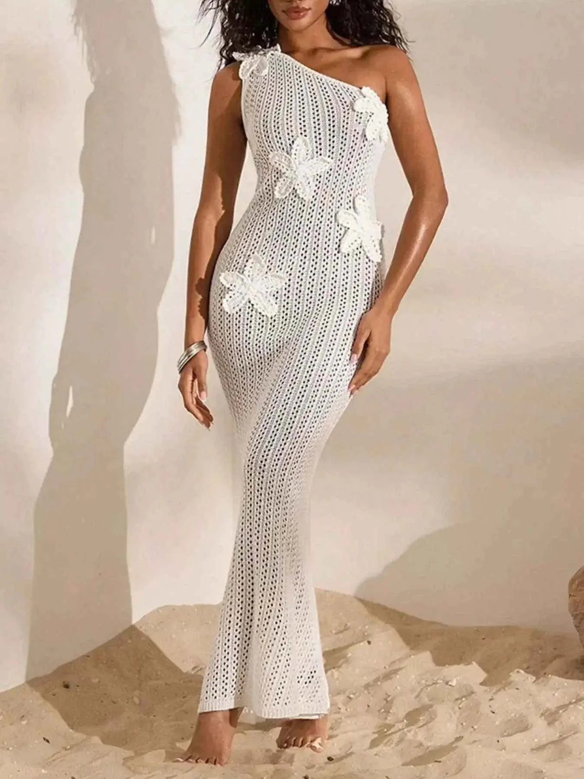 White one-shoulder crochet maxi dress with openwork pattern and floral appliques, slim fit silhouette One-Shoulder Crochet Maxi Dress.