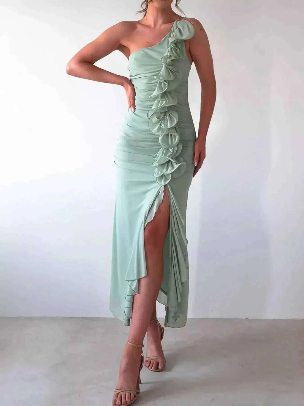 One-Shoulder Ruffle Slit Dress in light green polyester with ruched body, cascading ruffle detail, and thigh-high slit
