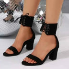 Black polyester Open Toe Block Heels with a lace-up ankle strap and mid-height block heel design on feet.