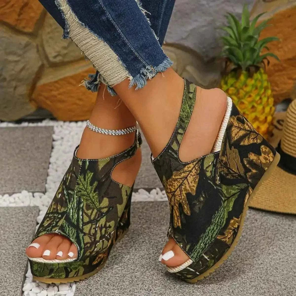 Open Toe Wedge Sandals in green and brown leaf camouflage pattern with cutout sides, high wedge heels, and ankle strap
