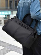 Oxford Cloth Travel Bag in black oxford cloth with a large rectangular shape and carrying handles.