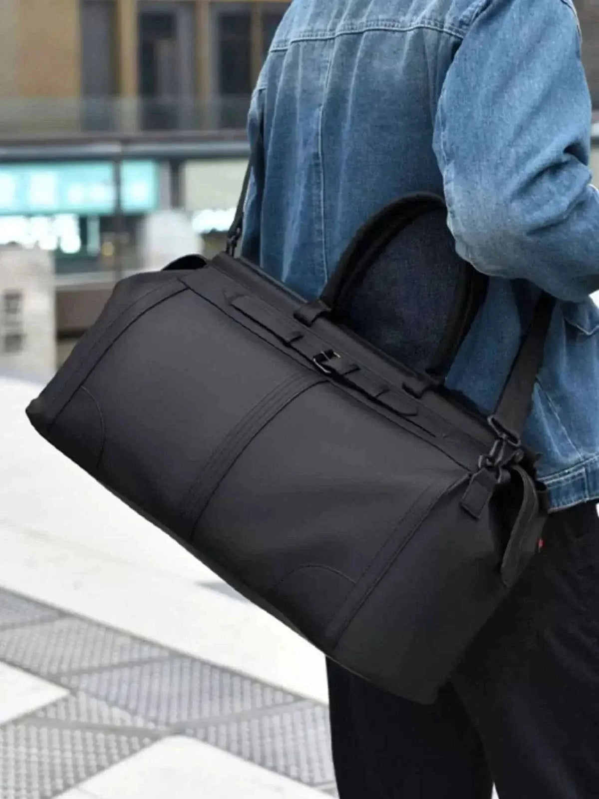 Oxford Cloth Travel Bag in black oxford cloth with a large rectangular shape and carrying handles.