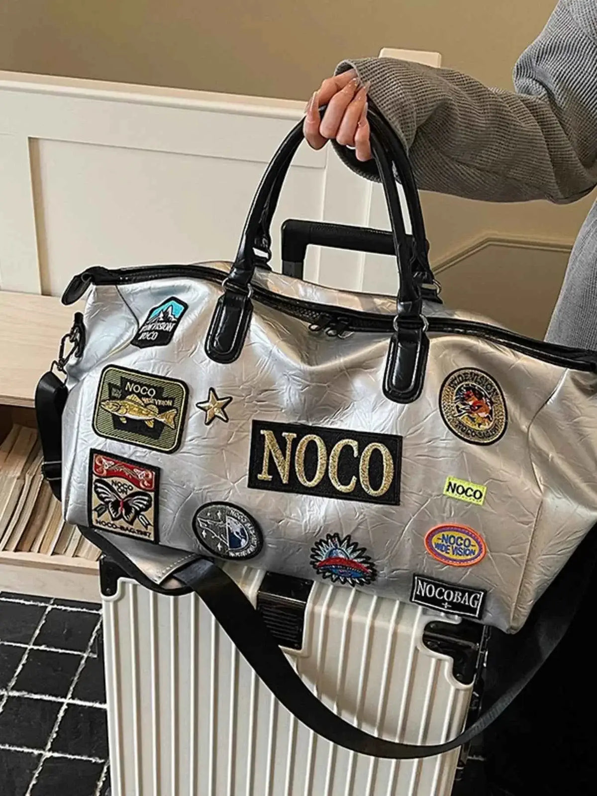 Patchwork Embellished Travel Bag in silver PU leather with multiple colorful patches and black handles and strap