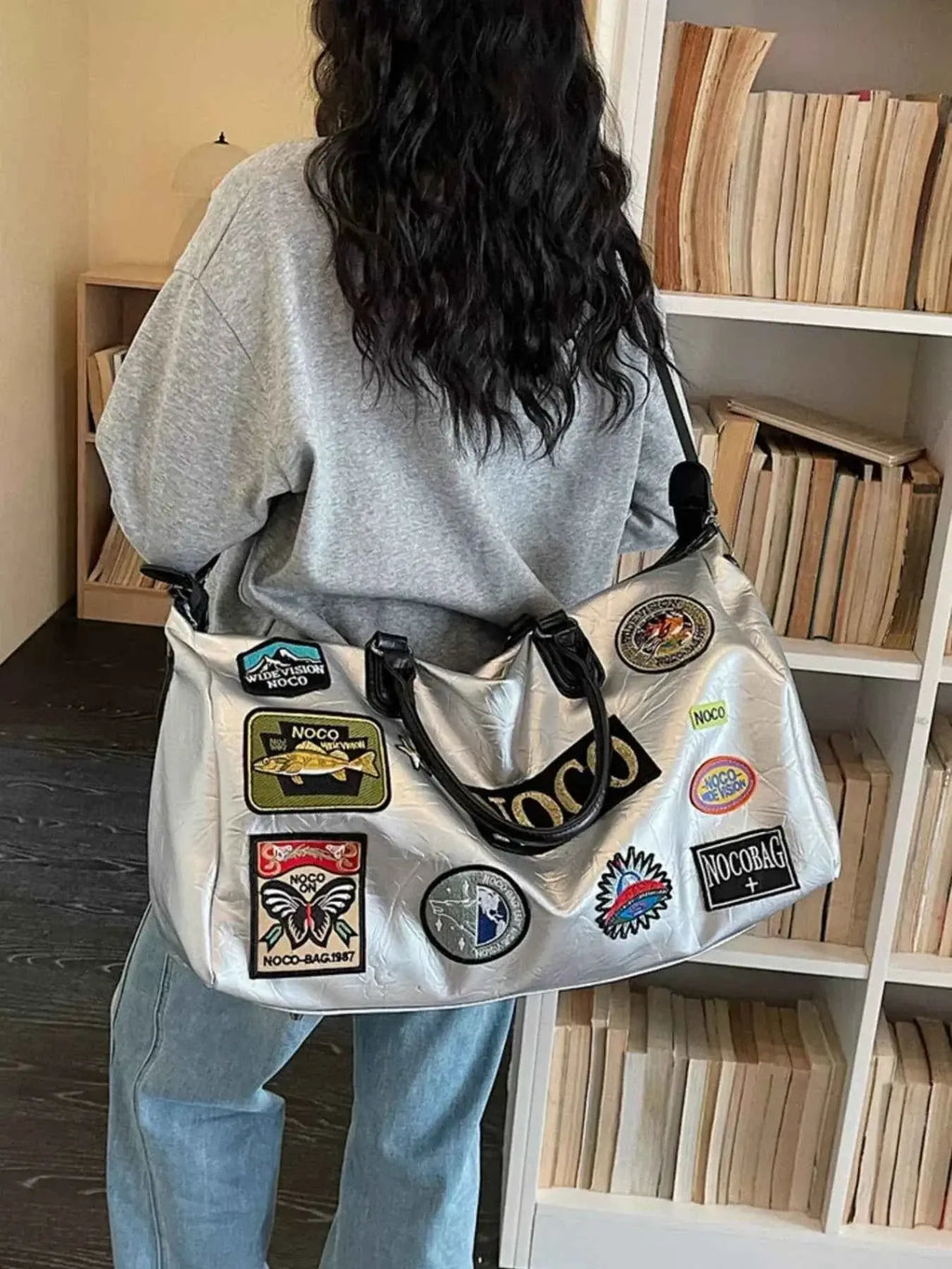 Large silver PU leather Patchwork Embellished Travel Bag with multiple colorful patches worn over shoulder