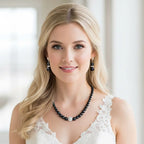 Pave Ball & Pearl Strand Necklace featuring black pearls with a central pave ball pendant worn by a blonde woman with matching black pearl earrings