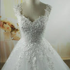 Pearl Ball Gown wedding dress featuring white lace applique, intricate pearl embellishments, and floral details on a sleeveless bodice