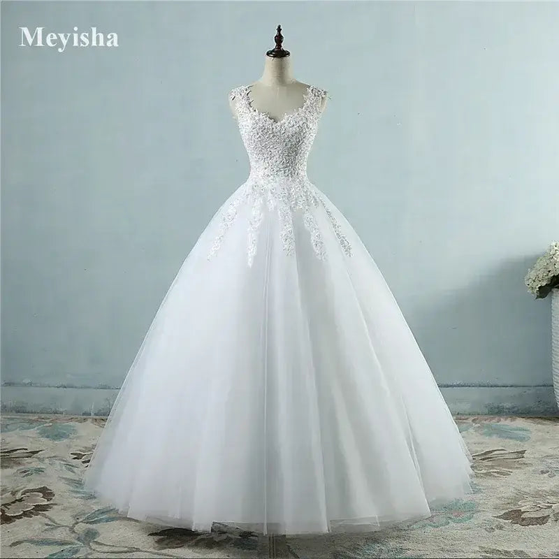 Pearl Ball Gown with intricate lace bodice, pearl embellishments, and voluminous white tulle skirt in classic ball gown silhouette