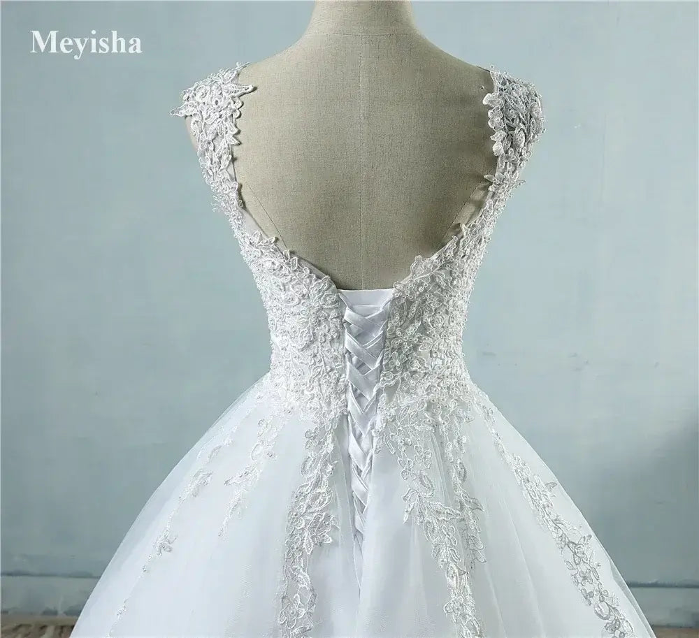 Pearl Ball Gown wedding dress in white with lace applique and pearl embellishments on a lace-up corset back