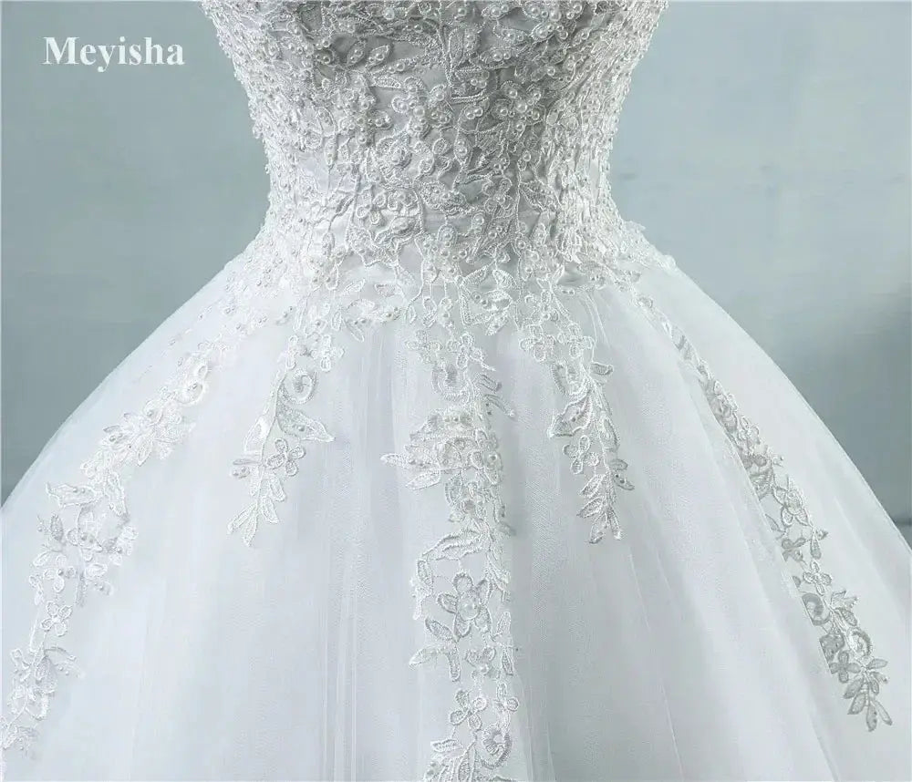 Pearl Ball Gown wedding dress with white lace bodice and delicate floral appliques on voluminous tulle skirt