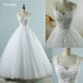 Pearl Ball Gown wedding dress in white with intricate lace and pearl embellishments on bodice and straps, full tulle skirt