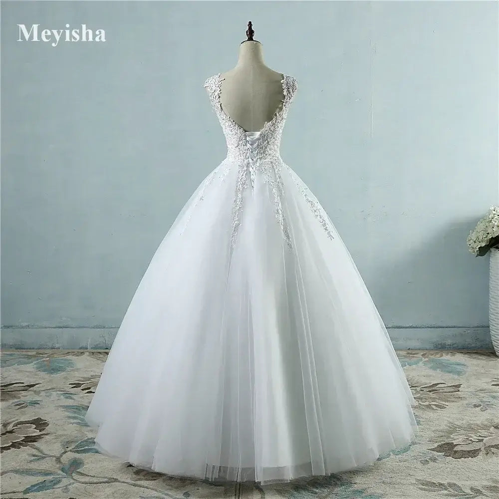 Pearl Ball Gown white wedding dress with sleeveless lace bodice and full tulle skirt on mannequin