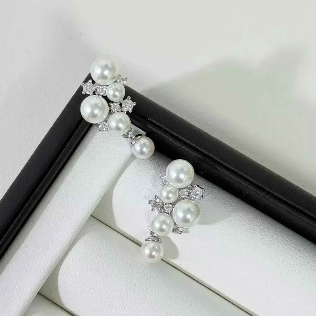 Pearl Cluster Earrings with white synthetic pearls and sparkling zircon stones set in silver tone metal