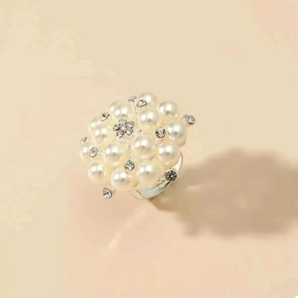 Pearl Cluster Ring featuring white synthetic pearls and clear rhinestones set on a silver-plated band in a clustered design.