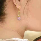 Pearl Drop Earrings featuring gold-plated hooks with small white and purple resin pearls hanging from them