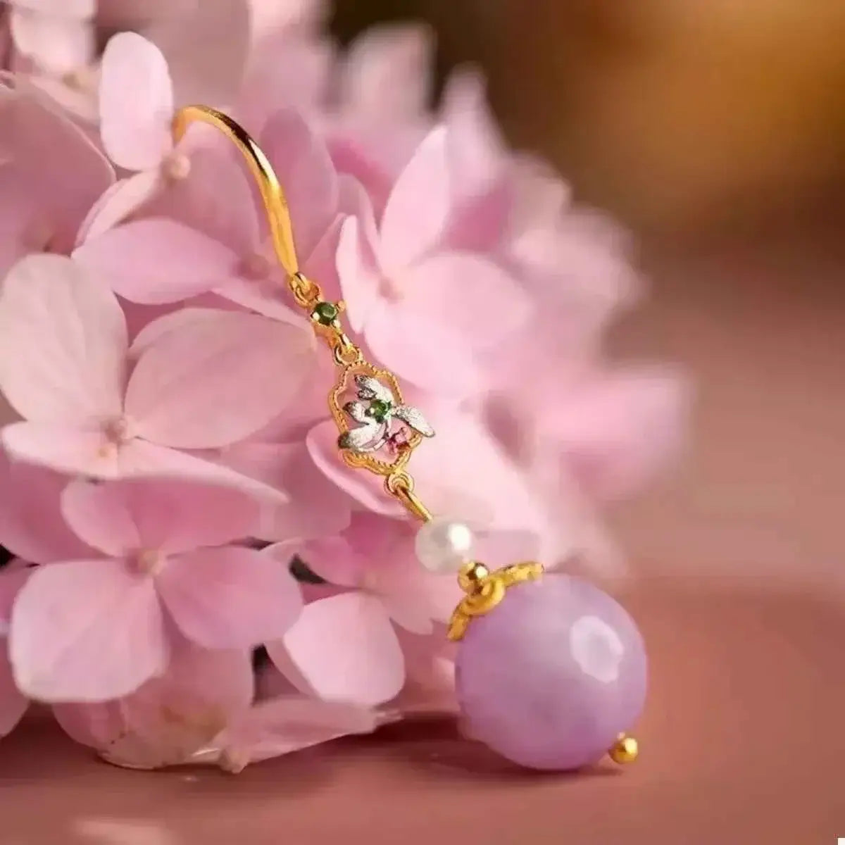 Pearl Drop Earrings featuring 18K gold-plated hook, delicate pink floral enamel charm, small white pearl, and a round lavender resin bead