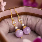 Pearl Drop Earrings with gold-plated hooks, small white pearls, and large round purple resin beads