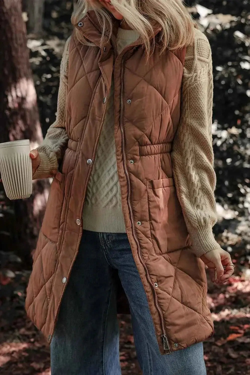 Pocketed Zipper and Button Vest in brown quilted polyester with front pockets, zipper and snap buttons, long length