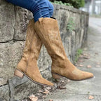 Point Toe Block Heels boots in tan suede with decorative stitching and mid-height block heels worn with blue jeans.