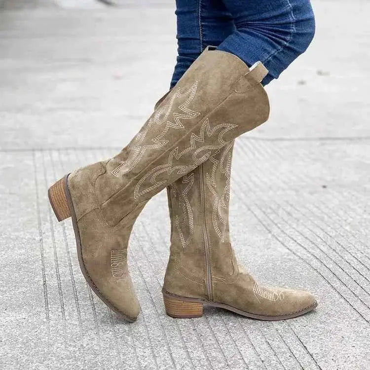 Point Toe Block Heels beige suede boots with decorative stitching and mid rubber heel, knee-high design worn with jeans.