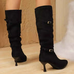 Black suede knee-high boots with pointed toes, slim high heels, and decorative buckles, featuring Point Toe Kitten Heels.